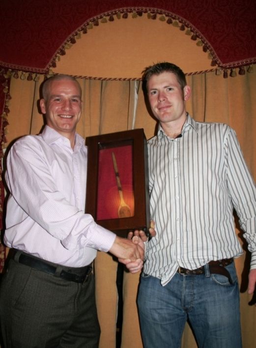 Willie Darragh takes ownership of the Wooden Spoon from Peter O'Neill